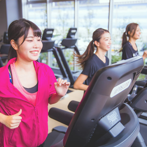 ランニングマシンで運動する女性たち